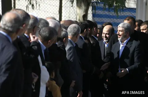 Hamas chief Khaled Meshaal shakes hands with Palestinian leaders upon his arrival in Rafah, southern Gaza, on December 7, 2012. Meshaal is making his first-ever visit to the Gaza Strip amid tight security for festivities...