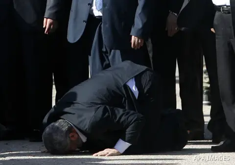 Hamas chief Khaled Meshaal prays, with his head to the ground, upon his arrival in Rafah, southern Gaza, on December 7, 2012. Meshaal is making his first-ever visit to the Gaza Strip amid tight security for festivities m...