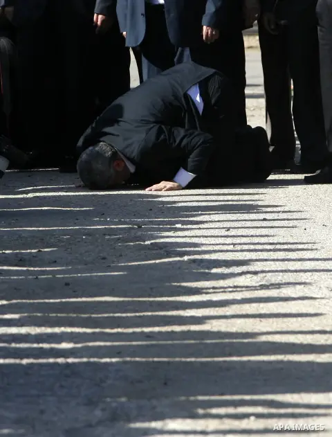 Hamas chief Khaled Meshaal prays, with his head to the ground, upon his arrival in Rafah, southern Gaza, on December 7, 2012. Meshaal is making his first-ever visit to the Gaza Strip amid tight security for festivities m...