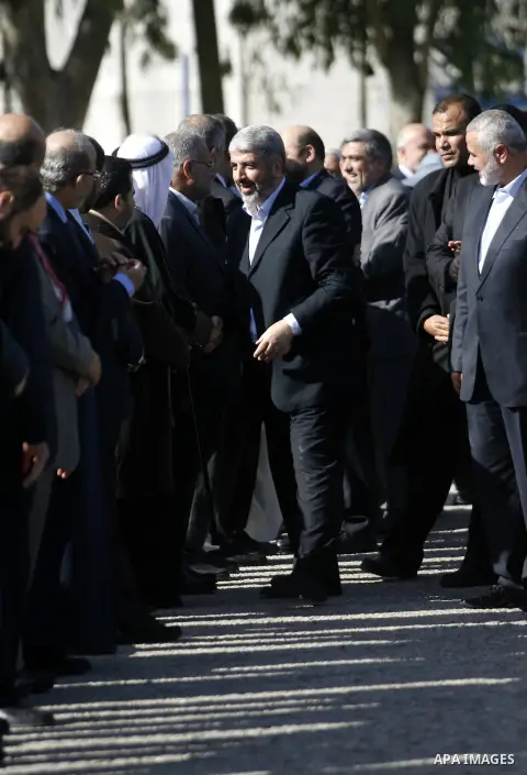 Hamas chief Khaled Meshaal shakes hands with Palestinian leaders upon his arrival in Rafah, southern Gaza, on December 7, 2012. Meshaal is making his first-ever visit to the Gaza Strip amid tight security for festivities...