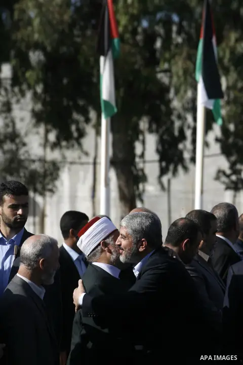 Hamas chief Khaled Meshaal hugs a Palestinian man upon his arrival in Rafah, southern Gaza, on December 7, 2012. Meshaal is making his first-ever visit to the Gaza Strip amid tight security for festivities marking the ru...