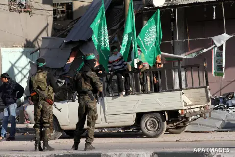 Masked Hamas security men stand guard during a parade following the arrival of Hamas leader-in-exile Khaled Meshaal in Rafah, southern Gaza, on December 7, 2012. Meshaal is making his first-ever visit to the Gaza Strip a...
