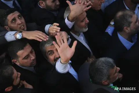 Hamas chief Khaled Meshaal and Palestinian prime minister in Gaza Strip Ismail Haniyeh, wave to the crowd upon his arrival in Gaza City December 7, 2012. Meshaal is making his first-ever visit to the Gaza Strip amid tigh...