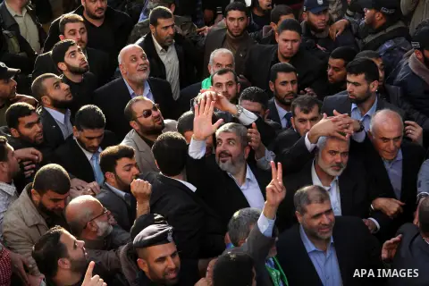 Hamas chief Khaled Meshaal and Palestinian prime minister in Gaza Strip Ismail Haniyeh, wave to the crowd upon his arrival in Gaza City December 7, 2012. Meshaal is making his first-ever visit to the Gaza Strip amid tigh...