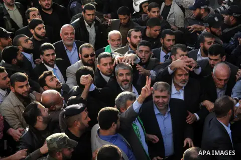 Hamas chief Khaled Meshaal and Palestinian prime minister in Gaza Strip Ismail Haniyeh, wave to the crowd upon his arrival in Gaza City December 7, 2012. Meshaal is making his first-ever visit to the Gaza Strip amid tigh...