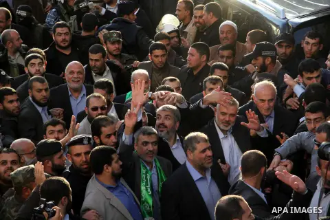 Hamas chief Khaled Meshaal and Palestinian prime minister in Gaza Strip Ismail Haniyeh, wave to the crowd upon his arrival in Gaza City December 7, 2012. Meshaal is making his first-ever visit to the Gaza Strip amid tigh...