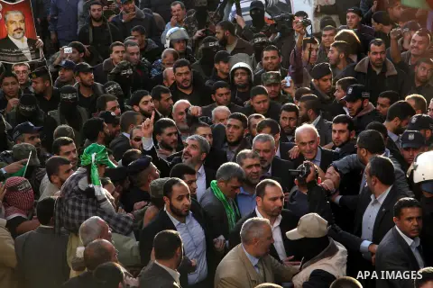 Hamas chief Khaled Meshaal and Palestinian prime minister in Gaza Strip Ismail Haniyeh, wave to the crowd upon his arrival in Gaza City December 7, 2012. Meshaal is making his first-ever visit to the Gaza Strip amid tigh...