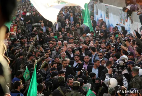 Hamas chief Khaled Meshaal and Palestinian prime minister in Gaza Strip Ismail Haniyeh, wave to the crowd upon his arrival in Gaza City December 7, 2012. Meshaal is making his first-ever visit to the Gaza Strip amid tigh...