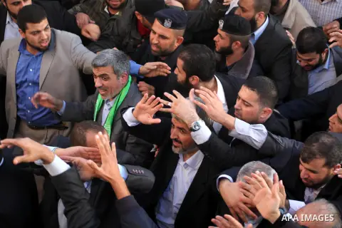 Hamas chief Khaled Meshaal with Palestinian prime minister in Gaza Strip Ismail Haniyeh waves to the crowd upon his arrival in Gaza City December 7, 2012. Meshaal is making his first-ever visit to the Gaza Strip amid tig...