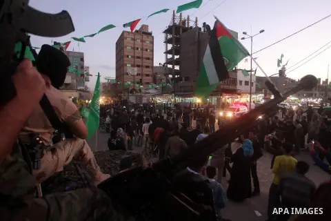 Masked Hamas security men stand guard during a parade following the arrival of Hamas leader-in-exile Khaled Meshaal in Rafah, southern Gaza, on December 7, 2012. Meshaal is making his first-ever visit to the Gaza Strip a...