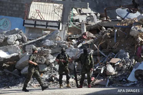 Masked Hamas security men stand guard during a parade following the arrival of Hamas leader-in-exile Khaled Meshaal in Rafah, southern Gaza, on December 7, 2012. Meshaal is making his first-ever visit to the Gaza Strip a...