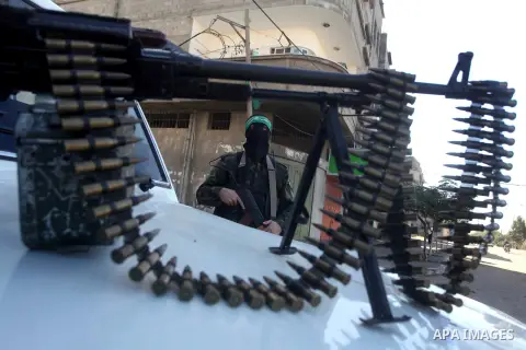 Masked Hamas security men stand guard during a parade following the arrival of Hamas leader-in-exile Khaled Meshaal in Rafah, southern Gaza, on December 7, 2012. Meshaal is making his first-ever visit to the Gaza Strip a...