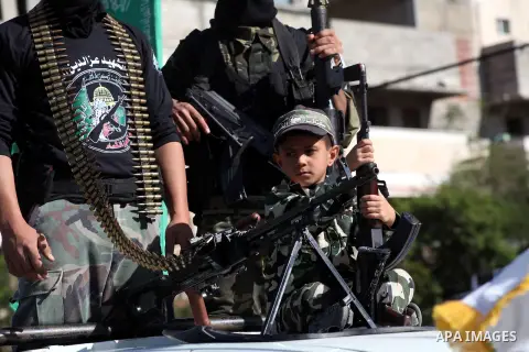 Masked Hamas security men stand guard during a parade following the arrival of Hamas leader-in-exile Khaled Meshaal in Rafah, southern Gaza, on December 7, 2012. Meshaal is making his first-ever visit to the Gaza Strip a...