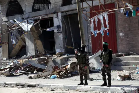 Masked Hamas security men stand guard during a parade following the arrival of Hamas leader-in-exile Khaled Meshaal in Rafah, southern Gaza, on December 7, 2012. Meshaal is making his first-ever visit to the Gaza Strip a...