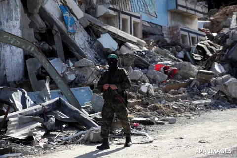 A masked Hamas security man stands guard during a parade following the arrival of Hamas leader-in-exile Khaled Meshaal in Rafah, southern Gaza, on December 7, 2012. Meshaal is making his first-ever visit to the Gaza Stri...