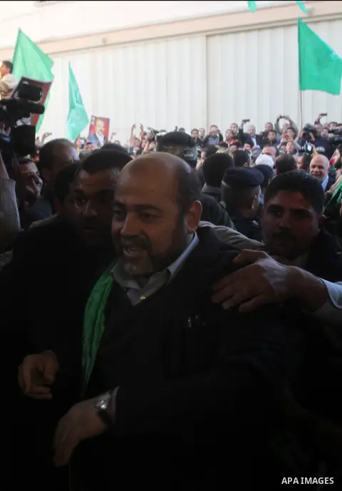 Hamas leader Mousa Abu Marzouq waves to the crowd upon his arrival in Gaza City December 7, 2012. Hamas chief Khaled Meshaal is making his first-ever visit to the Gaza Strip amid tight security for festivities marking th...