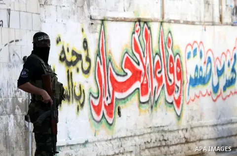 A Palestinian militant of the Ezzedine al-Qassam brigade, the armed wing Hamas, stands guard as they prepare for the arrival of the Islamist movement's exiled politburo chief Khaled Meshaal who is due in the Gaza Strip t...