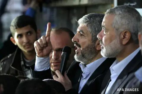 Hamas leader Khaled Meshaal visits the home of the late Hamas military commander Ahmed Al-Jaabari, who was killed in an Israeli air strike, in Gaza city on December 7, 2012. Meshaal is making his first-ever visit to the...