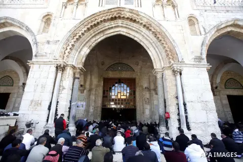 Palestinian Muslim worshippers pray outside the Dome of the Rock at al-Aqsa mosque compound, Islam's third holiest site, on December 7, 2012. Photo by Mahfouz Abu Turk