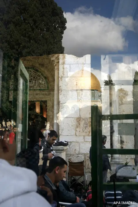 Palestinian Muslim worshippers pray outside the Dome of the Rock at al-Aqsa mosque compound, Islam's third holiest site, on December 7, 2012. Photo by Mahfouz Abu Turk