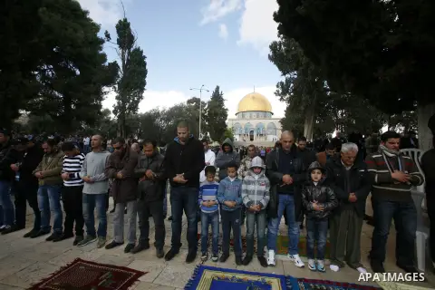 Palestinian Muslim worshippers pray outside the Dome of the Rock at al-Aqsa mosque compound, Islam's third holiest site, on December 7, 2012. Photo by Mahfouz Abu Turk
