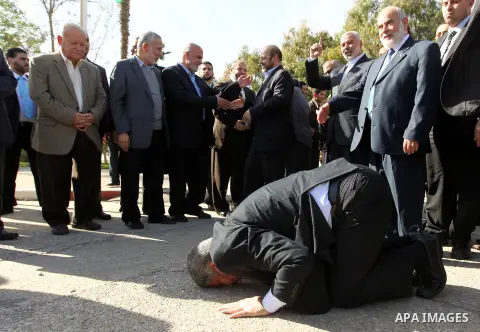 Hamas chief Khaled Meshaal prays, with his head to the ground, upon his arrival in Rafah, southern Gaza, on December 7, 2012. Meshaal is making his first-ever visit to the Gaza Strip amid tight security for festivities m...