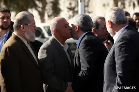 Hamas chief Khaled Meshaal shakes hands with Palestinian leaders upon his arrival in Rafah, southern Gaza, on December 7, 2012. Meshaal is making his first-ever visit to the Gaza Strip amid tight security for festivities...
