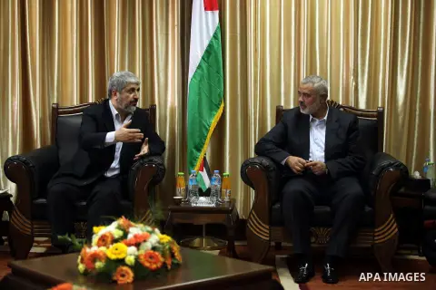 Hamas prime minister Ismail Haniya shows Haniya (L) greeting Palestinian Hamas leader in exile Khaled Meshaal upon the latter's arrival in the Gaza Strip from the Rafah border crossing on December 7, 2012. Meshaal made h...