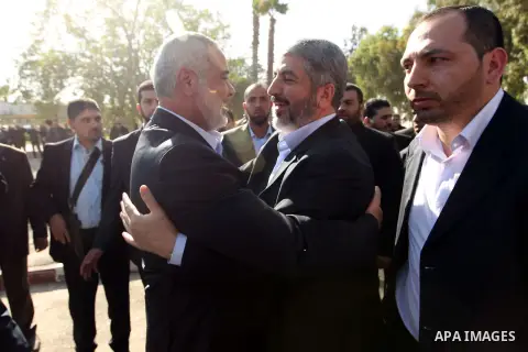Hamas prime minister Ismail Haniya shows Haniya greeting Palestinian Hamas leader in exile Khaled Meshaal upon the latter's arrival in the Gaza Strip from the Rafah border crossing on December 7, 2012. Meshaal made his f...