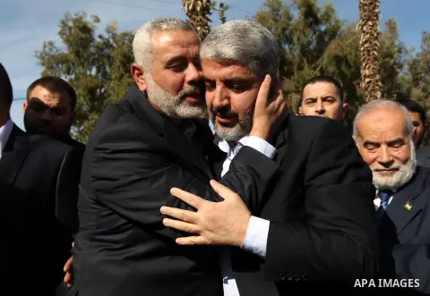 Hamas prime minister Ismail Haniya shows Haniya (L) greeting Palestinian Hamas leader in exile Khaled Meshaal upon the latter's arrival in the Gaza Strip from the Rafah border crossing on December 7, 2012. Meshaal made h...