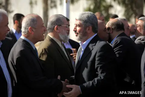Hamas chief Khaled Meshaal shakes hands with Palestinian leaders upon his arrival in Rafah, southern Gaza, on December 7, 2012. Meshaal is making his first-ever visit to the Gaza Strip amid tight security for festivities...