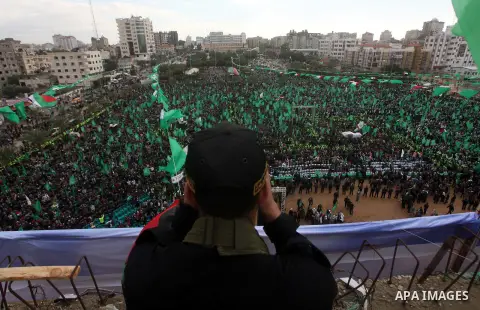 A member of Hamas stands guard during rally marking the 25th anniversary of the Islamist movement's founding in Gaza City on December 8, 2012. Hamas chief Khaled Meshaal arrived to Gaza strip on December 7 during his fir...
