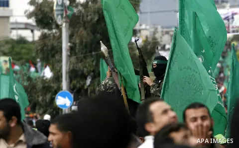 Masked Hamas security men stand guard during a Hamas rally marking the 25th anniversary of the Islamist movement's founding in Gaza City on December 8, 2012. Hamas chief Khaled Meshaal arrived to Gaza strip on December 7...