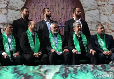 Hamas chief Khaled Meshaal, with senior Hamas leaders, takes part in a Hamas rally marking the 25th anniversary of the Islamist movement's founding in Gaza City on December 8, 2012. Meshaal arrived to Gaza strip on Decem...