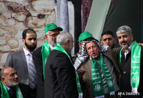 Hamas chief Khaled Meshaal, with senior Hamas leaders, takes part in a Hamas rally marking the 25th anniversary of the Islamist movement's founding in Gaza City on December 8, 2012. Meshaal arrived to Gaza strip on Decem...