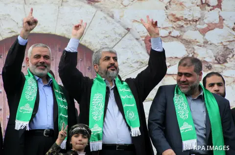 Hamas chief Khaled Meshaal, with senior Hamas leaders, takes part in a Hamas rally marking the 25th anniversary of the Islamist movement's founding in Gaza City on December 8, 2012. Meshaal arrived to Gaza strip on Decem...