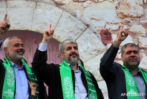 Hamas chief Khaled Meshaal, with senior Hamas leaders, takes part in a Hamas rally marking the 25th anniversary of the Islamist movement's founding in Gaza City on December 8, 2012. Meshaal arrived to Gaza strip on Decem...