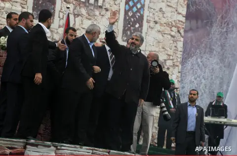 Hamas chief Khaled Meshaal, with senior Hamas leaders, takes part in a Hamas rally marking the 25th anniversary of the Islamist movement's founding in Gaza City on December 8, 2012. Meshaal arrived to Gaza strip on Decem...