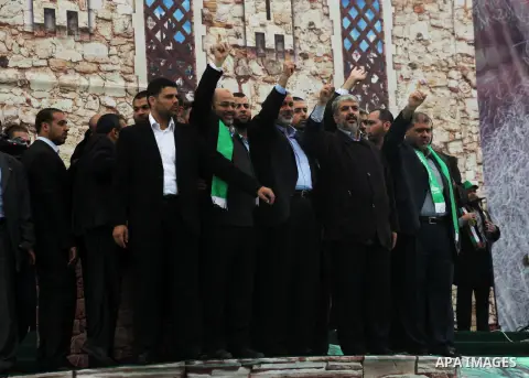 Hamas chief Khaled Meshaal, with senior Hamas leaders, takes part in a Hamas rally marking the 25th anniversary of the Islamist movement's founding in Gaza City on December 8, 2012. Meshaal arrived to Gaza strip on Decem...