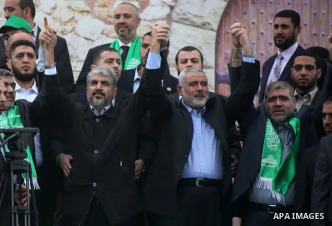 Hamas chief Khaled Meshaal, with senior Hamas leaders, takes part in a Hamas rally marking the 25th anniversary of the Islamist movement's founding in Gaza City on December 8, 2012. Meshaal arrived to Gaza strip on Decem...