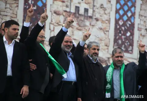 Hamas chief Khaled Meshaal, with senior Hamas leaders, takes part in a Hamas rally marking the 25th anniversary of the Islamist movement's founding in Gaza City on December 8, 2012. Meshaal arrived to Gaza strip on Decem...