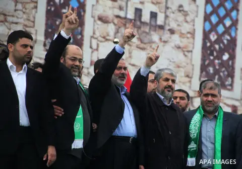 Hamas chief Khaled Meshaal, with senior Hamas leaders, takes part in a Hamas rally marking the 25th anniversary of the Islamist movement's founding in Gaza City on December 8, 2012. Meshaal arrived to Gaza strip on Decem...