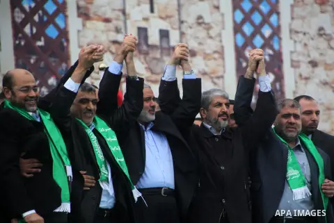 Hamas chief Khaled Meshaal, with senior Hamas leaders, takes part in a Hamas rally marking the 25th anniversary of the Islamist movement's founding in Gaza City on December 8, 2012. Meshaal arrived to Gaza strip on Decem...