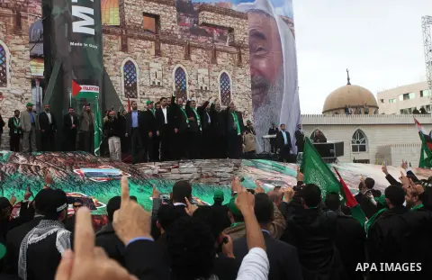 Hamas chief Khaled Meshaal, with senior Hamas leaders, takes part in a Hamas rally marking the 25th anniversary of the Islamist movement's founding in Gaza City on December 8, 2012. Meshaal arrived to Gaza strip on Decem...
