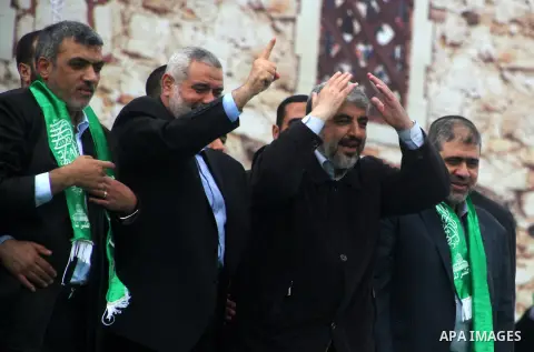 Hamas chief Khaled Meshaal, with senior Hamas leaders, takes part in a Hamas rally marking the 25th anniversary of the Islamist movement's founding in Gaza City on December 8, 2012. Meshaal arrived to Gaza strip on Decem...