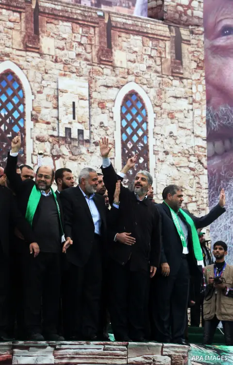 Hamas chief Khaled Meshaal, with senior Hamas leaders, takes part in a Hamas rally marking the 25th anniversary of the Islamist movement's founding in Gaza City on December 8, 2012. Meshaal arrived to Gaza strip on Decem...