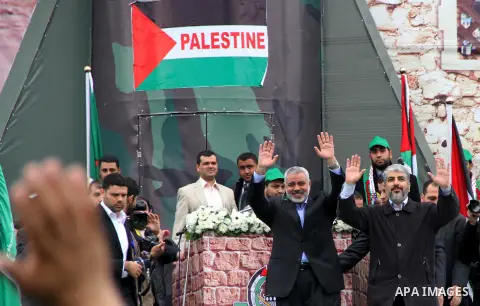 Hamas chief Khaled Meshaal, with senior Hamas leaders, takes part in a Hamas rally marking the 25th anniversary of the Islamist movement's founding in Gaza City on December 8, 2012. Meshaal arrived to Gaza strip on Decem...