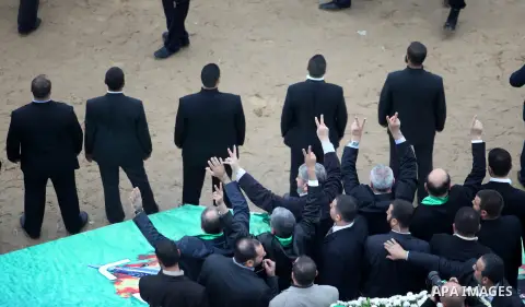 Hamas chief Khaled Meshaal, with senior Hamas leaders, takes part in a Hamas rally marking the 25th anniversary of the Islamist movement's founding in Gaza City on December 8, 2012. Meshaal arrived to Gaza strip on Decem...