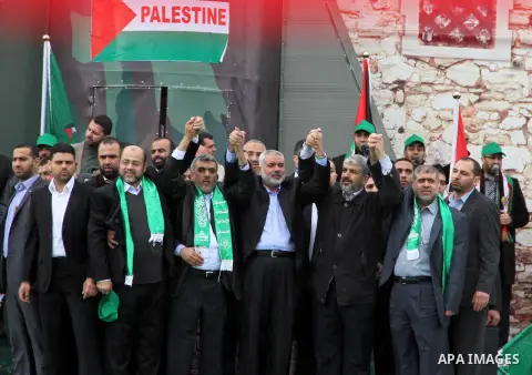 Hamas chief Khaled Meshaal, with senior Hamas leaders, takes part in a Hamas rally marking the 25th anniversary of the Islamist movement's founding in Gaza City on December 8, 2012. Meshaal arrived to Gaza strip on Decem...