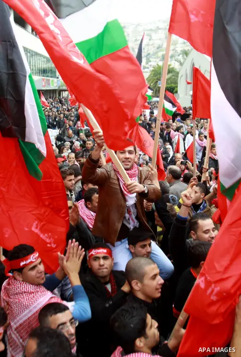 Supporters of the Popular Front for the Liberation of Palestine (PFLP) carry the party flag during a rally to mark the 45th anniversary of the establishment of the PFLP in the West Bank city of Nablus on December 8, 2012...